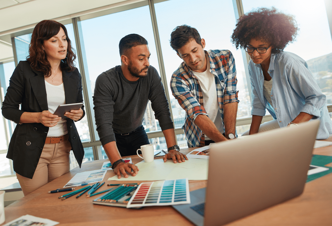 Managers working together with a business coaching consultant for leadership team development to help them nurture creativity and innovation within their leadership team.